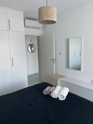 a bedroom with two towels on a bed with a mirror at Northern Cyprus Iskele Bogaz Abelia One plus One Sea View in Boğaz