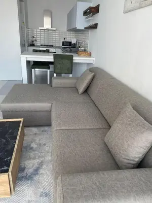 a couch in a living room with a kitchen at Northern Cyprus Iskele Bogaz Abelia One plus One Sea View in Boğaz