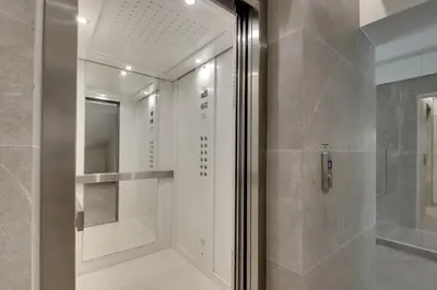 a bathroom with a shower and a mirror at Oniro Suites Makenzy in Larnaka