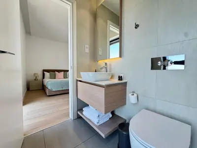 a bathroom with a sink and a toilet at SkyHigh Park View Living in Nicosia
