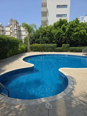 a swimming pool with blue water in a building at Regina by the Sea in Limassol