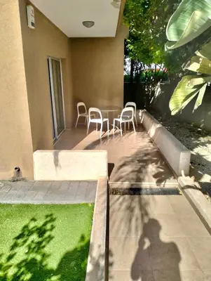 a shadow of a man on a patio with a table and chairs at Regina by the Sea in Limassol