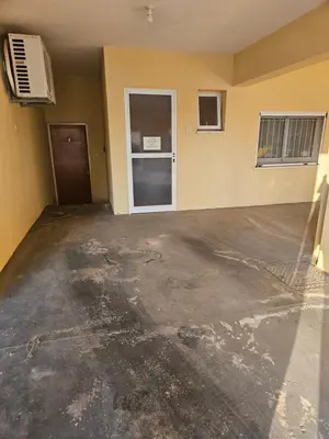 an empty room with a concrete floor and a door at ισόγειο διαμέρισμα με αυλή στην περιοχή Κάππαρη κατάλληλο για οικογενεια in Paralimni
