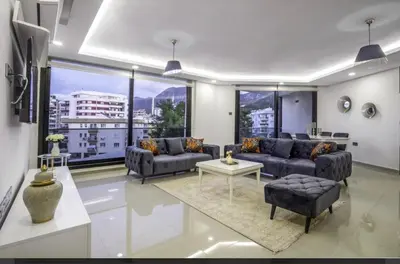 a living room with couches and a large window at Avrasya city in Ayios Dhometios