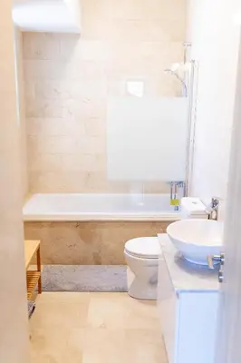 a bathroom with a toilet and a sink and a tub at Cosmos Residence C102 in Paralimni