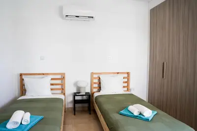 two beds sitting next to each other in a bedroom at Cosmos Residence C102 in Paralimni