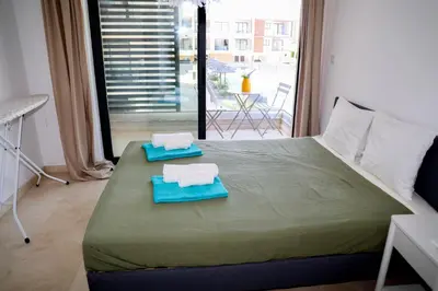 a bedroom with a bed with two towels on it at Cosmos Residence C102 in Paralimni