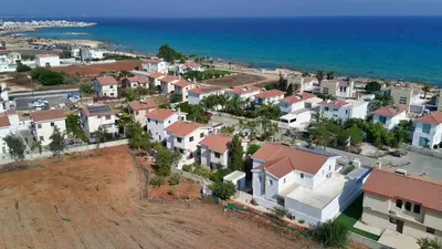 an aerial view of a town with houses and the ocean at Villa Emilia in Ayia Napa
