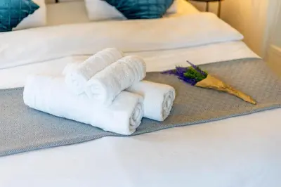 a pile of towels sitting on a bed at Zalihe Boutique Hotel North Nicosia in Nicosia