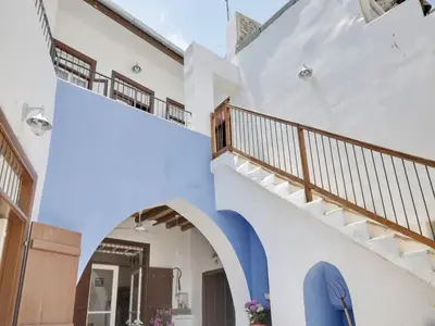 a staircase in a house with a blue surfboard at Lefkara View in Pano Lefkara