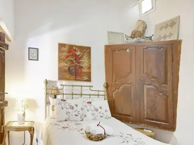 a bedroom with a bed and a wooden cabinet at Lefkara View in Pano Lefkara