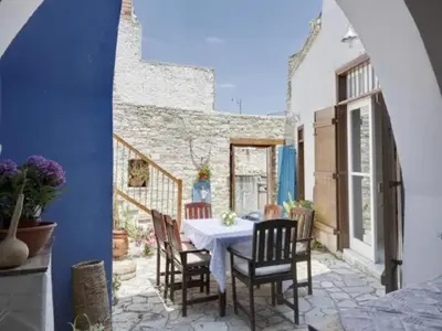 a dining room with a table and chairs on a patio at Lefkara View in Pano Lefkara