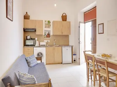 a living room with a couch and a kitchen at Lefkara View in Pano Lefkara