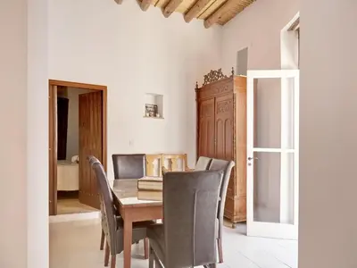 a dining room with a wooden table and chairs at Lefkara View in Pano Lefkara