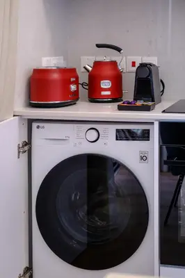 a washing machine with two appliances on top of it at Artemis 104 - Seaside Stories in Livadhia