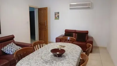 a dining room with a table and a couch at Unique City room in Larnaka