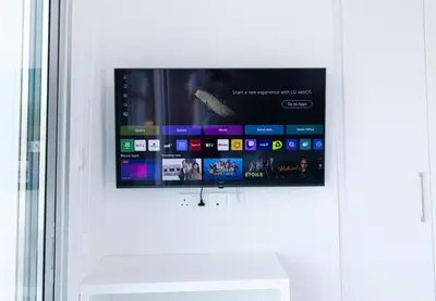 a flat screen tv hanging on a white door at Dahlia Napa Villa in Ayia Napa