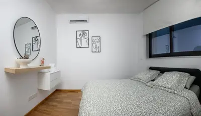 a white bedroom with a bed and a mirror at Sunny 1-Bedroom Apartment - StaysbyDais in Larnaka