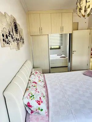 a bedroom with a white bed and a room with a bed sqor at Nicosia's Diamond in Nicosia