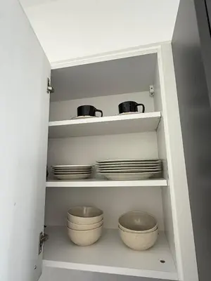 a cupboard with plates and bowls in a kitchen at Yenikent's Diamond in Nicosia