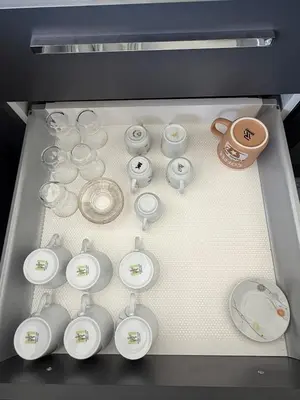 a drawer filled with white plates and bowls and a cup at Yenikent's Diamond in Nicosia