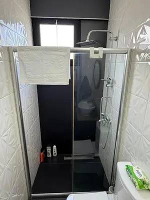 a bathroom with a shower with a toilet and a sink at Yenikent's Diamond in Nicosia
