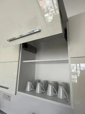 a kitchen with a row of silver pots at Yenikent's Diamond in Nicosia