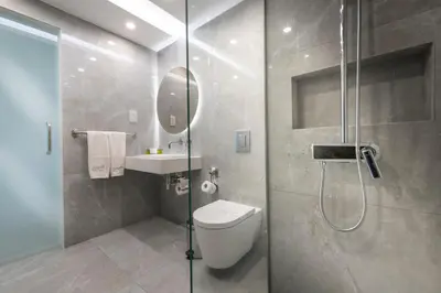 a bathroom with a shower and a toilet and a sink at Pernera Beach Hotel in Protaras