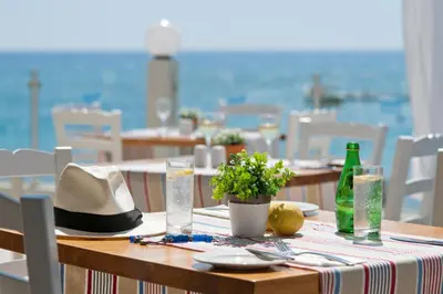 a table with a hat and glasses on top of it at Pernera Beach Hotel in Protaras