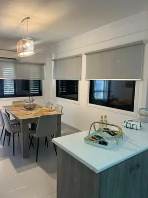 a kitchen and dining room with a table and chairs at Lazuli Skyline & Sea View Penthouse in Larnaka