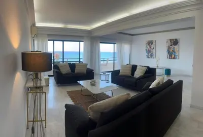 a living room with two couches and a table at Lazuli Skyline & Sea View Penthouse in Larnaka