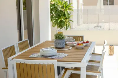a wooden table with bowls of food on it at Villa Chrystalla in Paralimni
