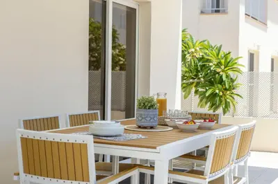 a white table and chairs on a patio at Villa Chrystalla in Paralimni