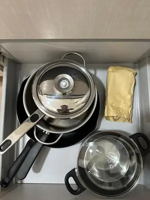 a kitchen with two pans and utensils in it at Finikoudes Central Apartment in Larnaka