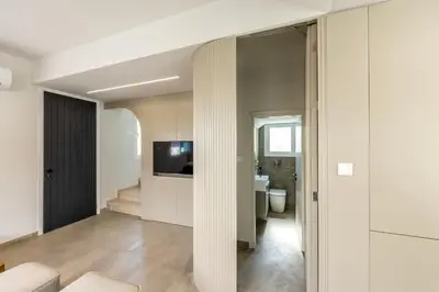 a living room with a sliding glass door leading to a bathroom at Villa Mesogeios 4 in Protaras