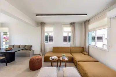 a living room with a couch and a table at Villa Mesogeios 4 in Protaras