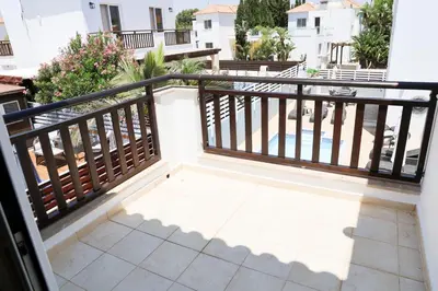 a balcony with a black railing and a tile floor at Agesilaos Seaview 33 in Ayia Napa