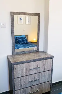 a dresser with a mirror on top of it at Central 2 bdr Flat St Lazaros - Phoenix Lodge in Larnaka