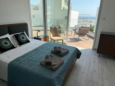 a bedroom with a bed with two towels on it at TooCoool Villa - Elite Sea Breeze in Ayia Napa