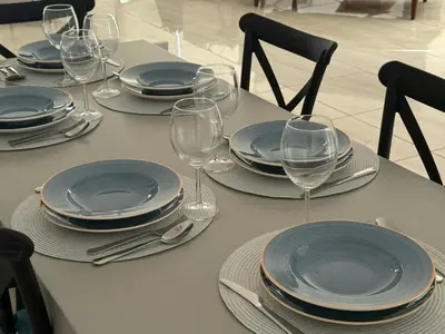a table with plates and wine glasses on it at TooCoool Villa - Elite Sea Breeze in Ayia Napa