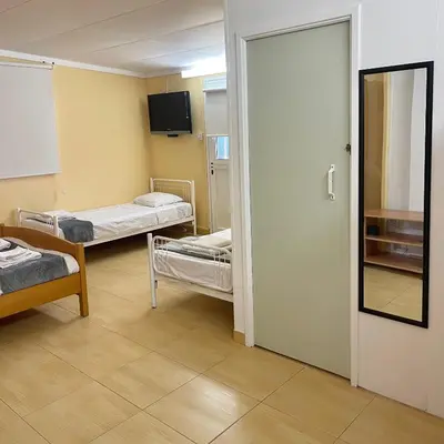 a hospital room with two beds and a door at Comfortable Vacation House in Protaras