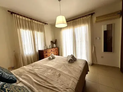 a bedroom with a large bed with towels on it at STAY Sunny Palms Penthouse in Voroklini