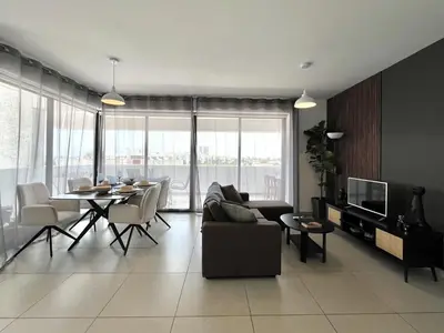 a living room with a couch and a table at STAY Sealine Apartment in Larnaka