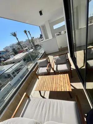 a balcony with two chairs and a table at Modern Designer Home in Larnaka