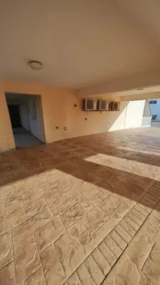 an empty room with a wooden floor in a building at Nissi Cove 2 Bedroom Apartment in Ayia Napa