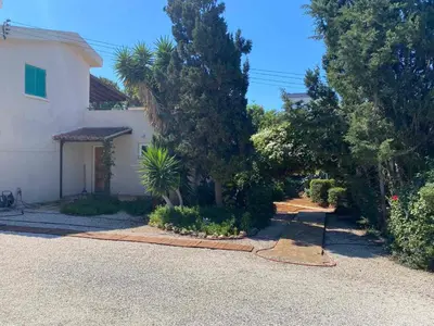a driveway of a house with trees and bushes at Konnos Villa in Protaras