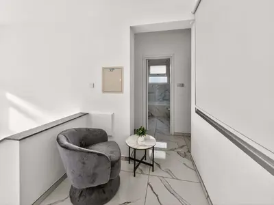 a living room with a chair and a table at Alassia Blue Villa in Protaras