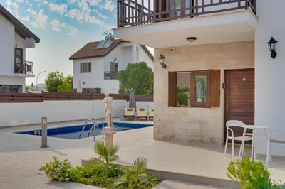 a villa with a swimming pool and a house at Amelia Beach Villa wpool -500mfrombeach in Voroklini