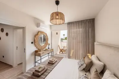 a bedroom with a bed and a mirror at Pallini 202 in Protaras