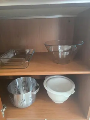 a wooden shelf with bowls and plates on it at Lazuli Penthouse City Center Ap 5 in Larnaka